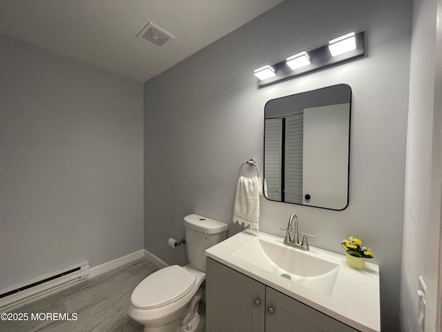 4B Greenwood Ln, Whiting, NJ 08759 - half bath featuring baseboard heating, baseboards, toilet, wood finished floors, and vanity