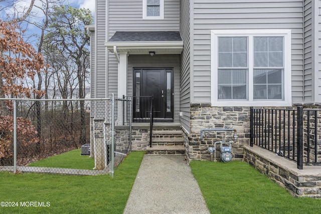 24 Golders Green Rd, Lakewood, NJ 08701 - doorway to property featuring stone siding and roof with shingles