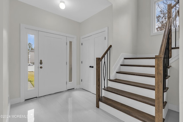 24 Golders Green Rd, Lakewood, NJ 08701 - foyer entrance featuring stairs, healthy amount of natural light, and baseboards