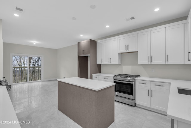 24 Golders Green Rd, Lakewood, NJ 08701 - kitchen featuring gas stove, white cabinets, light countertops, a kitchen island, and recessed lighting