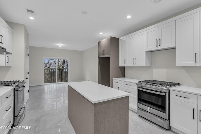 24 Golders Green Rd, Lakewood, NJ 08701 - kitchen with gas stove, range hood, white cabinetry, a kitchen island, and recessed lighting