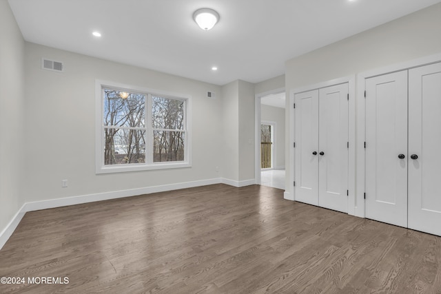 24 Golders Green Rd, Lakewood, NJ 08701 - unfurnished bedroom featuring multiple closets, wood finished floors, baseboards, and recessed lighting