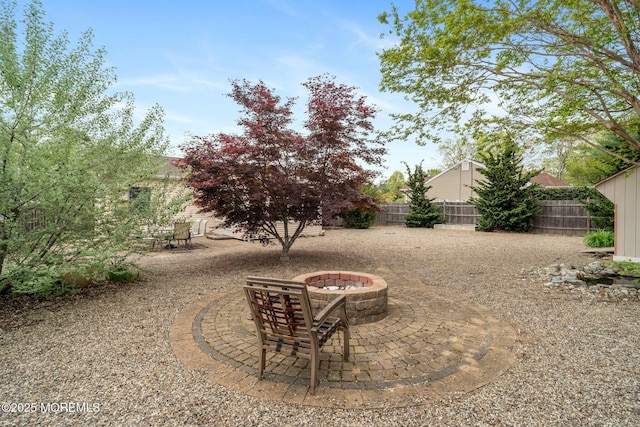 123 Nautilus Dr, Manahawkin, NJ 08050 - fenced backyard with a fire pit and a patio area