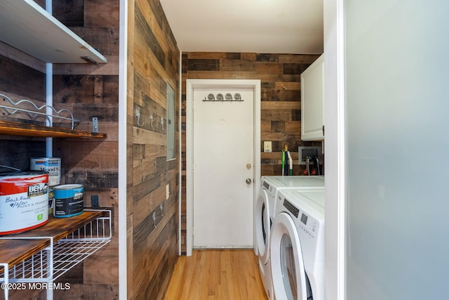 123 Nautilus Dr, Manahawkin, NJ 08050 - washroom with wooden walls, cabinet space, washing machine and dryer, and light wood-type flooring