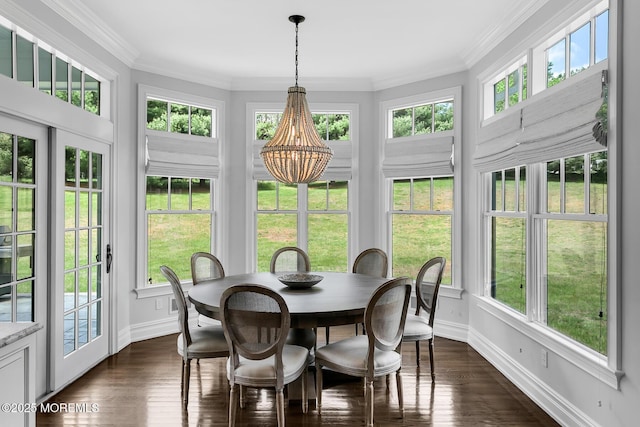 sunroom with a chandelier, baseboards, healthy amount of natural light, and crown molding