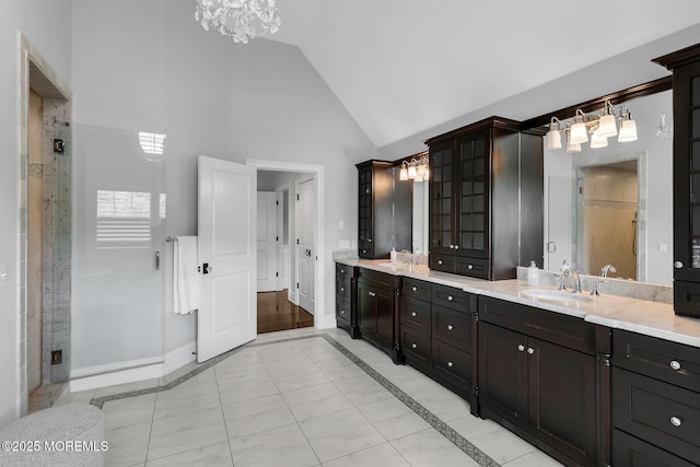 full bathroom featuring a chandelier, high vaulted ceiling, inlaid floor details, baseboards, and a shower stall