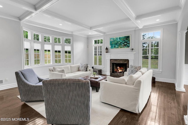 living area featuring a premium fireplace, coffered ceiling, baseboards, beam ceiling, and ornate columns
