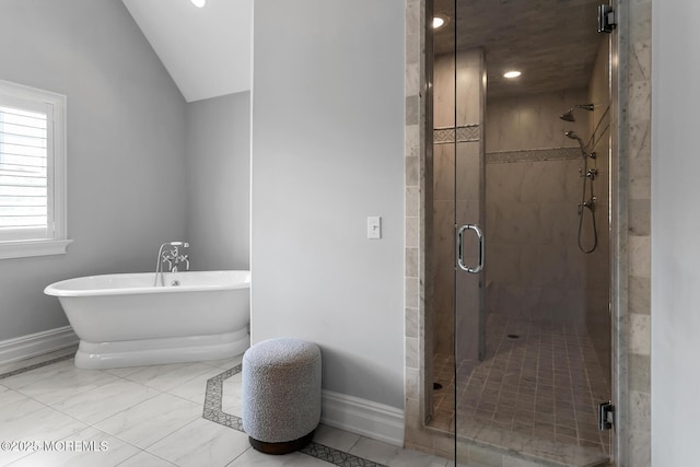 full bath featuring baseboards, a freestanding tub, a stall shower, lofted ceiling, and marble finish flooring