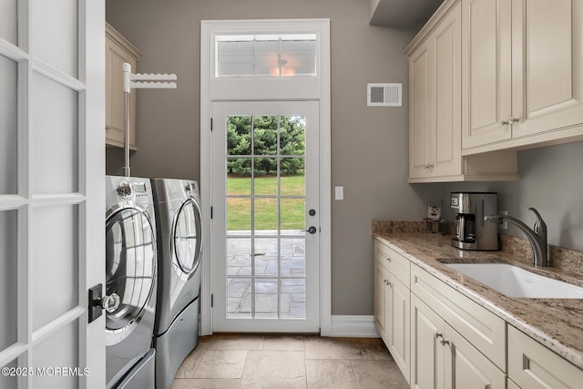 laundry room with cabinet space, washing machine and clothes dryer, and baseboards