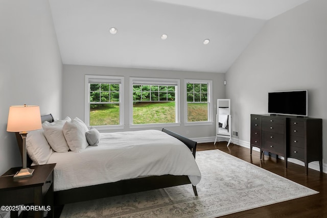 bedroom featuring lofted ceiling, wood finished floors, baseboards, and recessed lighting