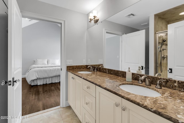 full bath with a shower stall, double vanity, ensuite bathroom, and tile patterned floors
