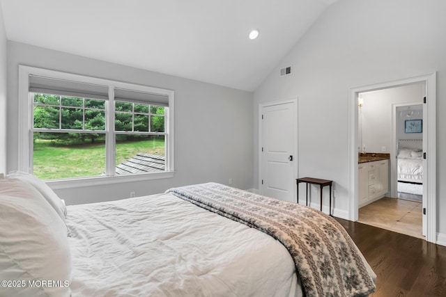 bedroom featuring high vaulted ceiling, wood finished floors, baseboards, ensuite bathroom, and recessed lighting