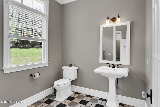 bathroom featuring baseboards, toilet, and tile patterned floors