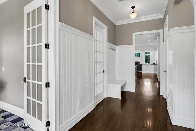 corridor featuring ornamental molding and dark wood-style floors