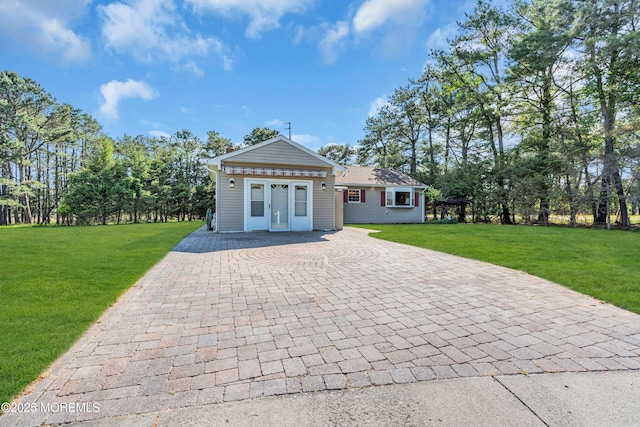 11 S Point Ct, Toms River, NJ 08757 - view of front of property with decorative driveway, french doors, a front lawn, and view of scattered trees