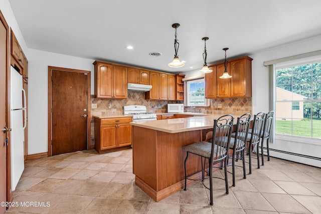 11 S Point Ct, Toms River, NJ 08757 - kitchen with under cabinet range hood, white appliances, a peninsula, tasteful backsplash, and recessed lighting