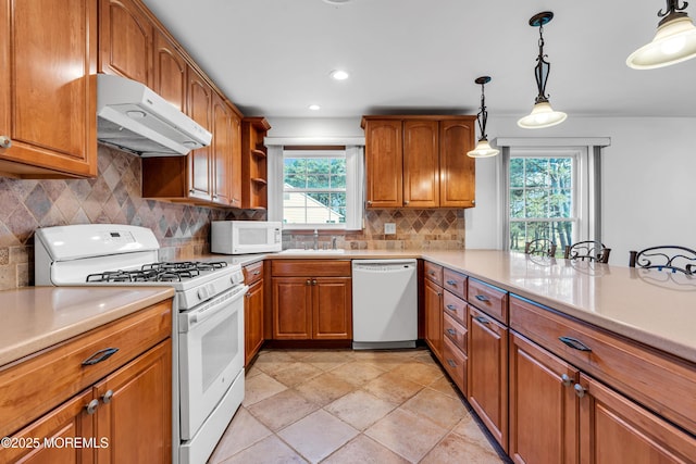 11 S Point Ct, Toms River, NJ 08757 - kitchen with white appliances, under cabinet range hood, brown cabinets, a sink, and healthy amount of natural light