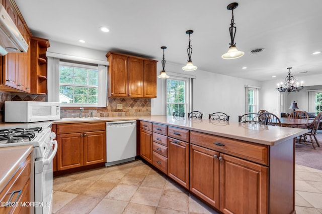 11 S Point Ct, Toms River, NJ 08757 - kitchen with white appliances, a sink, a peninsula, brown cabinetry, and recessed lighting