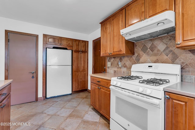 11 S Point Ct, Toms River, NJ 08757 - kitchen with white appliances, under cabinet range hood, decorative backsplash, brown cabinets, and light countertops