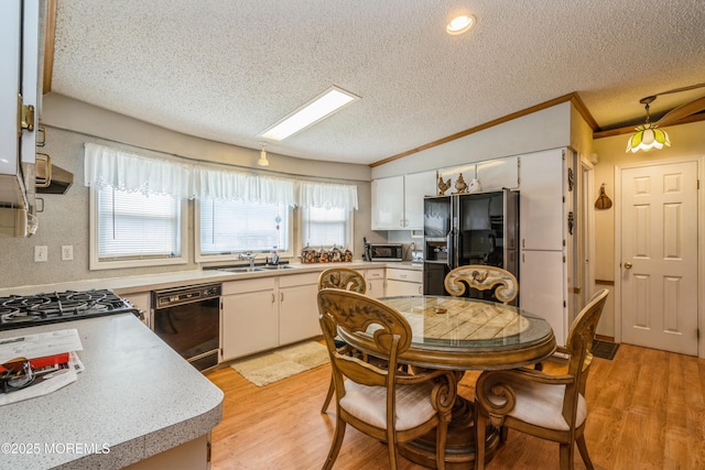9 Copperfield Dr, Cream Ridge, NJ 08514 - kitchen featuring black appliances, a textured ceiling, light wood-style flooring, crown molding, and light countertops