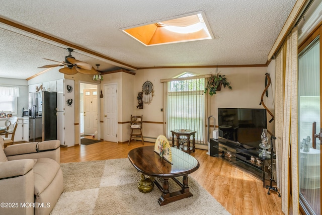 9 Copperfield Dr, Cream Ridge, NJ 08514 - living area with a textured ceiling, crown molding, light wood-style flooring, healthy amount of natural light, and a skylight