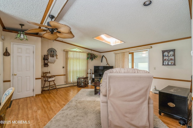9 Copperfield Dr, Cream Ridge, NJ 08514 - living room with a textured ceiling, a baseboard heating unit, ornamental molding, light wood finished floors, and a ceiling fan