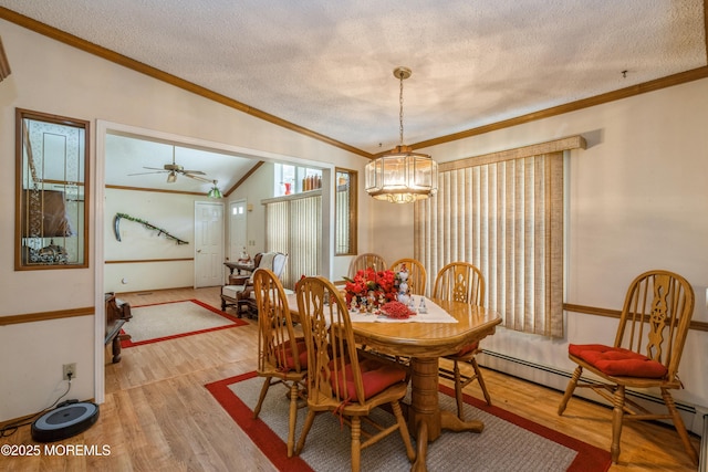 9 Copperfield Dr, Cream Ridge, NJ 08514 - dining area featuring a baseboard radiator, a textured ceiling, wood finished floors, lofted ceiling, and crown molding