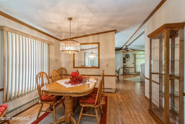 9 Copperfield Dr, Cream Ridge, NJ 08514 - dining room featuring a baseboard radiator, a textured ceiling, ornamental molding, a chandelier, and wood finished floors