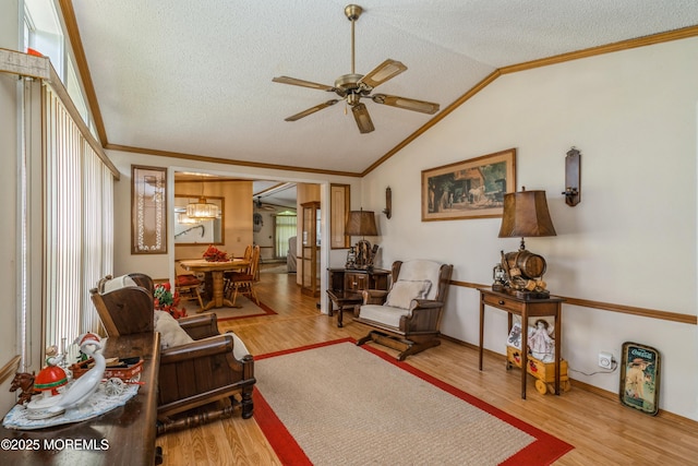9 Copperfield Dr, Cream Ridge, NJ 08514 - living area with ornamental molding, ceiling fan, vaulted ceiling, a textured ceiling, and wood finished floors
