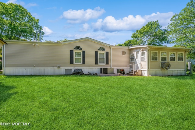 9 Copperfield Dr, Cream Ridge, NJ 08514 - rear view of house with entry steps and a lawn