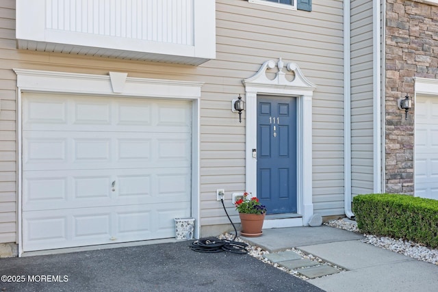 111 Warbler Way Unit 1000, Freehold, NJ 07728 - entrance to property featuring stone siding, driveway, and an attached garage