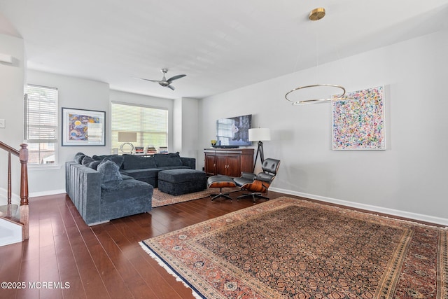 111 Warbler Way Unit 1000, Freehold, NJ 07728 - living area with dark wood-style flooring, baseboards, a ceiling fan, a chandelier, and stairs