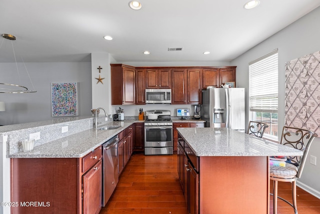 111 Warbler Way Unit 1000, Freehold, NJ 07728 - kitchen with appliances with stainless steel finishes, a sink, a peninsula, light stone countertops, and recessed lighting