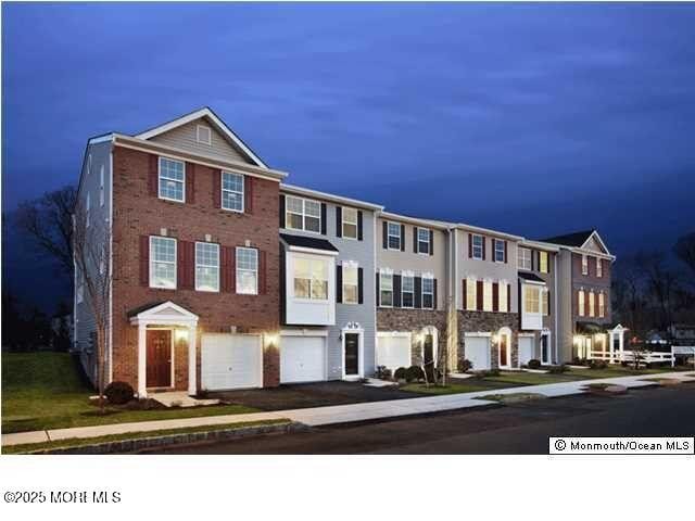 111 Warbler Way Unit 1000, Freehold, NJ 07728 - townhome / multi-family property featuring an attached garage and driveway