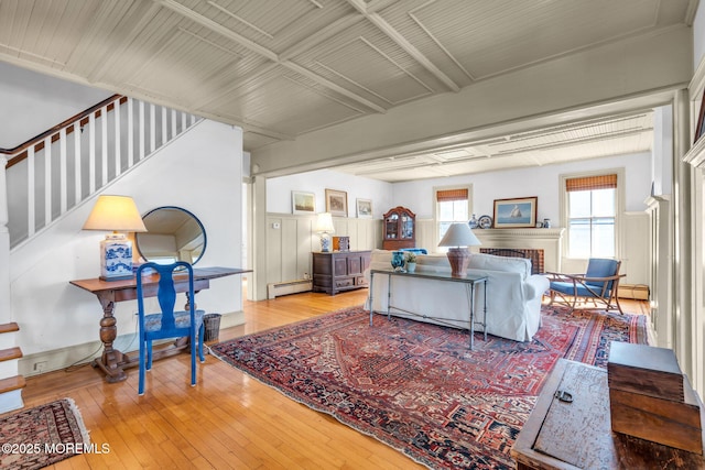 58 River Ave, Island Heights, NJ 08732 - living room featuring a baseboard heating unit, stairway, and hardwood / wood-style floors