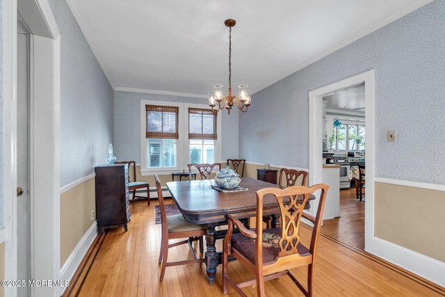 58 River Ave, Island Heights, NJ 08732 - dining area with light wood finished floors, crown molding, a chandelier, and a baseboard radiator