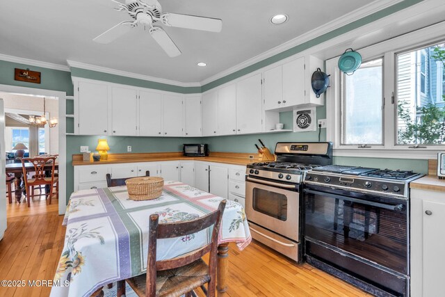 58 River Ave, Island Heights, NJ 08732 - kitchen with gas range, stainless steel gas range, open shelves, plenty of natural light, and crown molding
