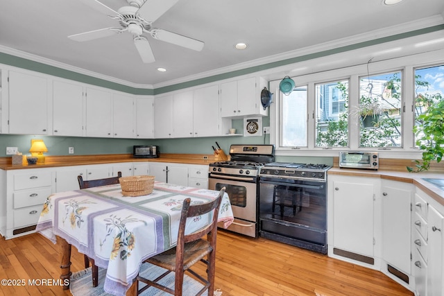 58 River Ave, Island Heights, NJ 08732 - kitchen featuring black range with gas cooktop, stainless steel gas stove, light wood-style floors, ornamental molding, and healthy amount of natural light