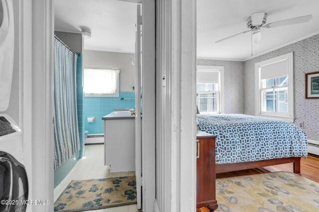 58 River Ave, Island Heights, NJ 08732 - bedroom with washer / clothes dryer, wallpapered walls, ornamental molding, multiple windows, and a baseboard radiator