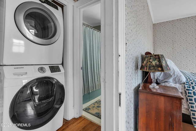 58 River Ave, Island Heights, NJ 08732 - laundry area with stacked washer / dryer, wallpapered walls, wood finished floors, and crown molding