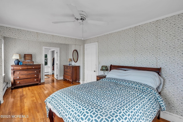 58 River Ave, Island Heights, NJ 08732 - bedroom featuring crown molding, wallpapered walls, wood finished floors, a ceiling fan, and a baseboard heating unit