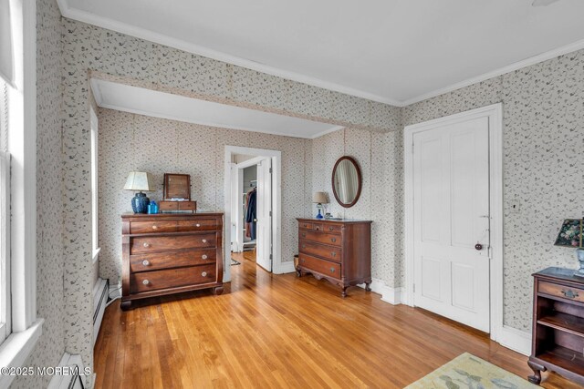58 River Ave, Island Heights, NJ 08732 - bedroom featuring wood finished floors, ornamental molding, wallpapered walls, and a baseboard radiator