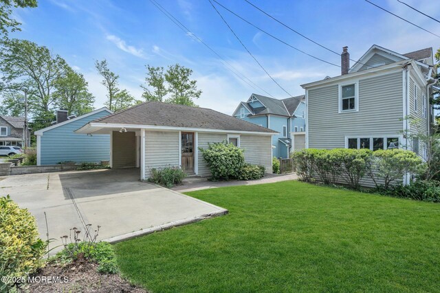 58 River Ave, Island Heights, NJ 08732 - view of front of property with a chimney, a front lawn, driveway, and a carport