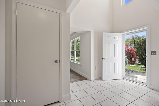 entrance foyer with baseboards and light tile patterned flooring