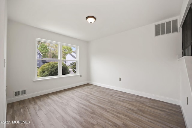 empty room featuring wood finished floors and baseboards