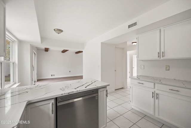 kitchen featuring dishwasher, white cabinetry, light stone counters, and light tile patterned flooring