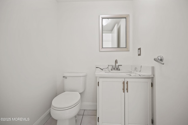 bathroom with baseboards, vanity, toilet, and tile patterned flooring