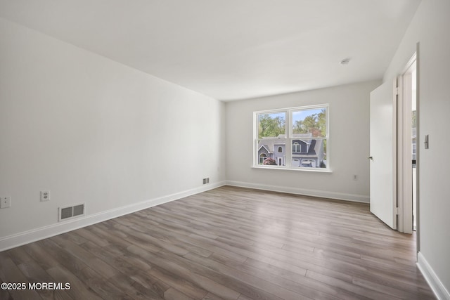 empty room with wood finished floors and baseboards