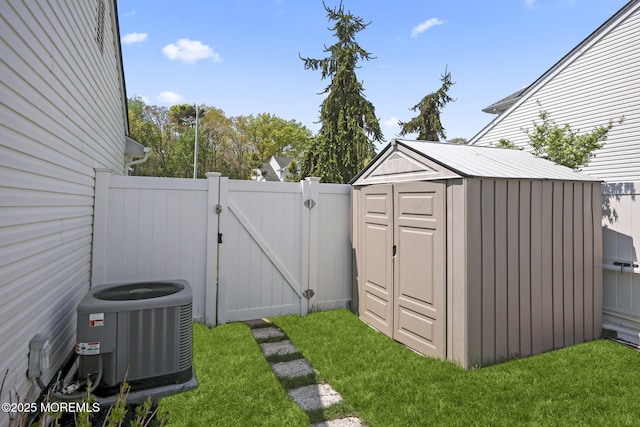 view of shed featuring a gate and cooling unit