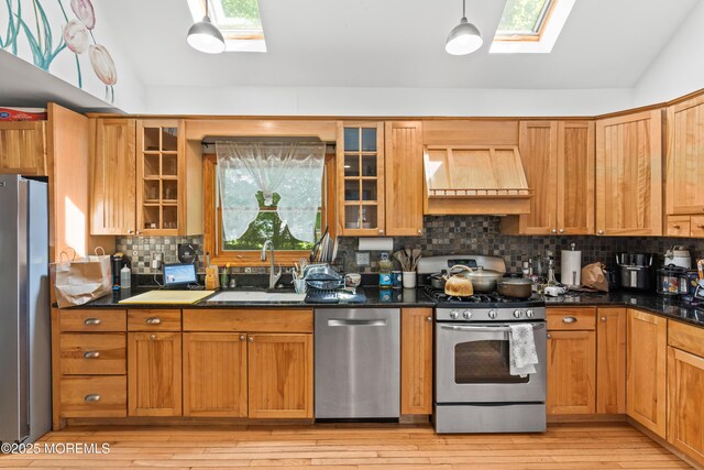 329 Hollywood Ave, Long Branch, NJ 07740 - kitchen with stainless steel appliances, a skylight, custom exhaust hood, vaulted ceiling, and a sink